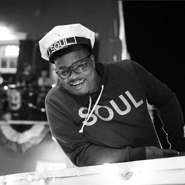 Professional New Orleans brass band musician smiling during a live performance