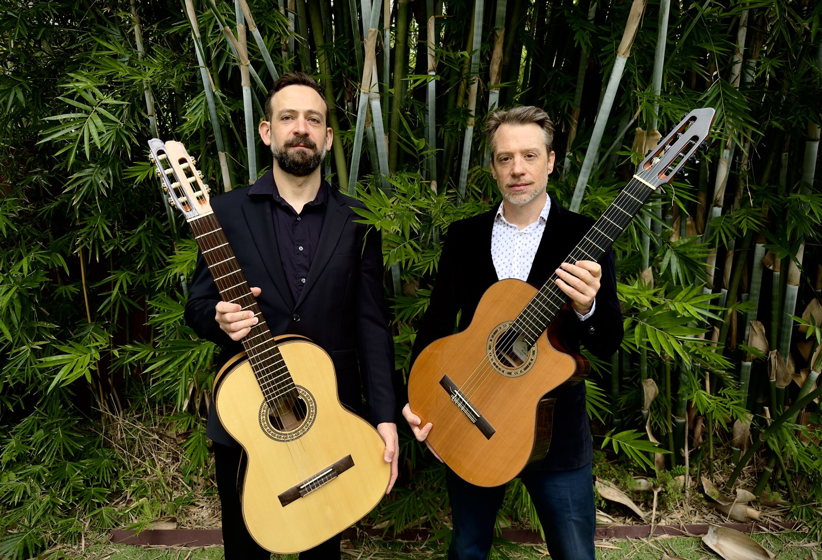 Le Deux guitar duo, Matt Johnson and Danny Abel, holding nylon-string guitars in New Orleans.